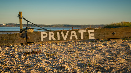 Sign: Private, seen at Shellness Beach on the Isle of Sheppey, Kent, England, UK