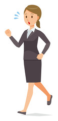 A business woman in a suit is running