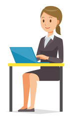 A business woman in a suit is operating a laptop computer