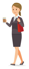 A business woman in a suit is walking with coffee
