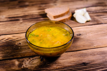 Vegetable soup in a glass bowl on wooden table