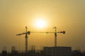 Building site with cranes and blue sky on everning