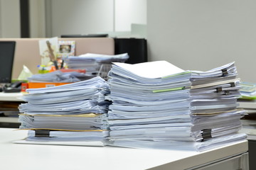 Pile of financial documents on white table at workplace,business concept.