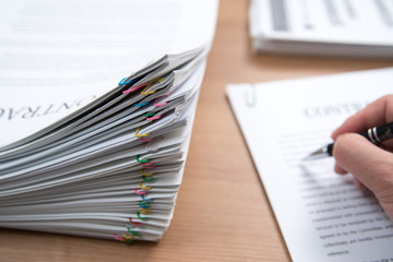 A pile of documents with the man in the document