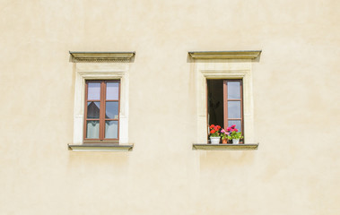 Beautiful windows on the wall of an old house.