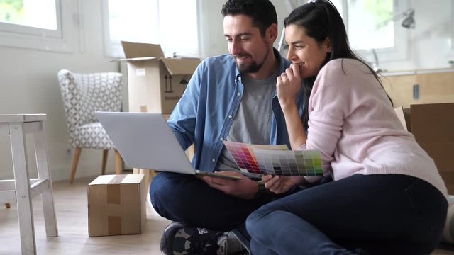 Couple choosing paint colours to reform house