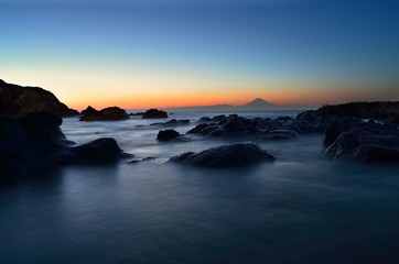 Mt. Fuji silhouette with reef at sunset slow shutter