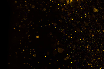 Falling golden glitter dark background
