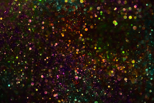Multicolored vibrant glitter dust background