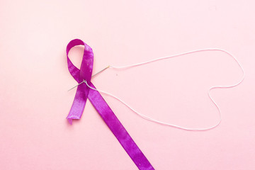stitching symbol cancer world day and heart shape with white thread 