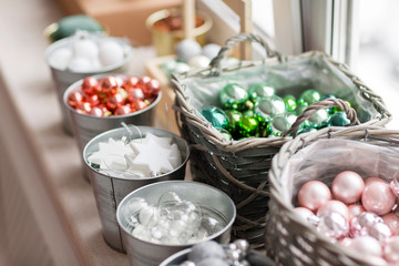 Many decorations. a lot of colorful, different Christmas toys ready to decorate the house. sorted by type in baskets