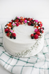 white cake with berries | side view