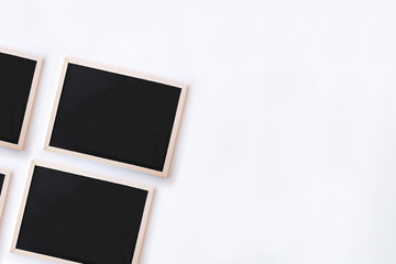White office desk table with chalkboards. Top view with copy space, flat lay.