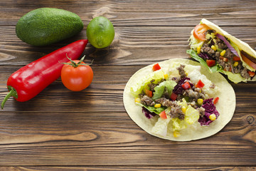 tacos  and ingredients on wooden table