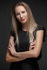 Fototapeta premium sexy fashion model with long hair, young European attractive, beautiful eyes, perfect skin is posing in studio for glamour vogue test photo shoot showing different poses. Picture taken in the studio