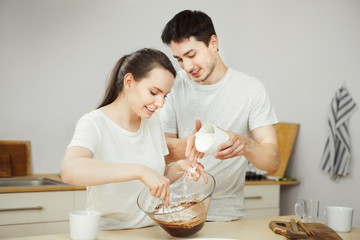 Obraz na płótnie Canvas Man and woman preparing sweet dessert together. Happy couple