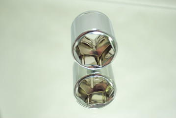 medium size chrome ratchet socket on mirror close-up