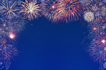 colourful fireworks background with space in the middle - obrazy, fototapety, plakaty