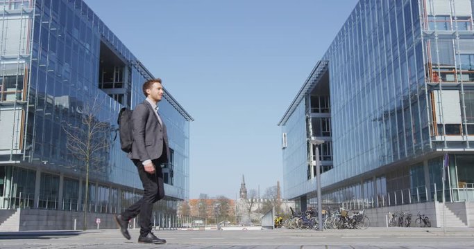 Business man. Young urban professional businessman walking to work wearing backpack wearing backpack. Businessman in 30s in Copenhagen, Denmark, Scandinavia.