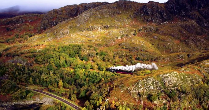 Aerial view of Steam Train crossing Glenfinnan Viaduct Scotland