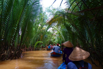 My Tho, Vietnam: Tourist at Mekong River Delta jungle cruise with unidentified craftman and...