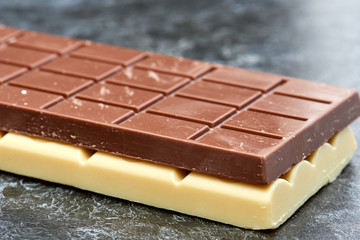 black chocolate lies on the white chocolate