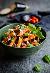 Traditional Italian Pasta alla Norma with eggplant, tomato, cheese and basil