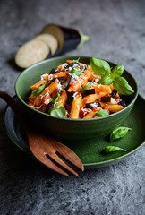 Traditional Italian Pasta alla Norma with eggplant, tomato, cheese and basil