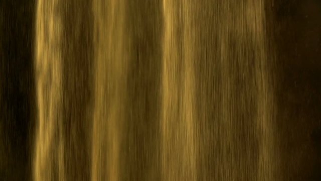 Sand falling in slow motion on dark black background in abstract fashion form. Studio slow motion footage