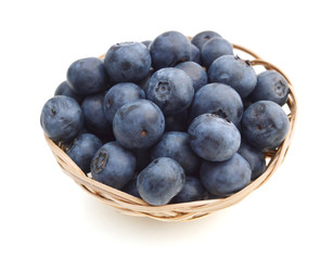 composition from a fresh bow blueberry in basket on the white isolated background