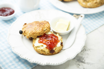 Fresh homemade scones with butter and jam