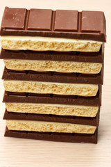 stack of six black and five white porous chocolate closeup on the  table