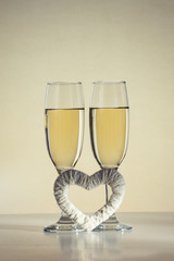 Two glasses of champagne and a white heart handmade