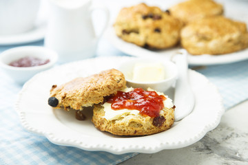 Fresh homemade scones with butter and jam