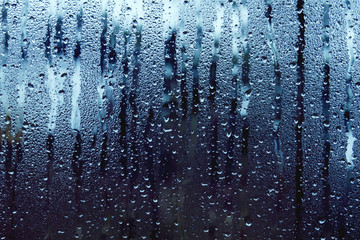 Fototapeta na wymiar condensation droplets and rain in a window 