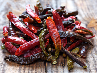 Dried chili peppers on a wooden board