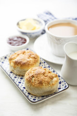 Fresh homemade scones with butter and jam