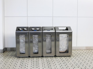 4 different trash containers for each type of waste: canned paper, paper and other