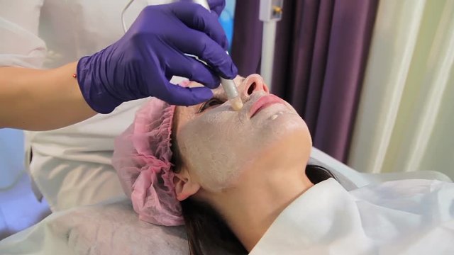 The woman on the procedure of lightening the skin. The patient's face in close-up. The appliance dermapen. Oriental medicine bbglow.