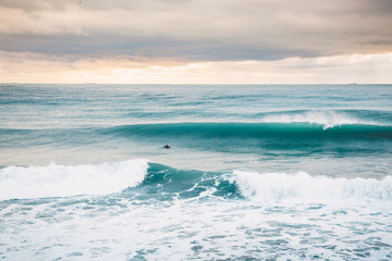 Fototapeta na wymiar Perfect big breaking Ocean barrel wave and alone surfer