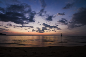 sunset on the beach and light house