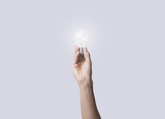 hand holding light bulb, concept of new technology ideas with innovation and creativity.