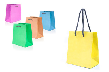 Mock-up with yellow, green, orange, blue and pink paper bags for shopping on white background.