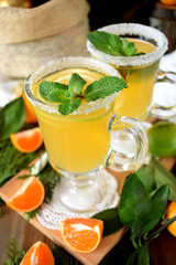 Yellow cocktail in Irish mugs decorated with sugar border and mint