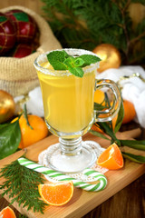 Yellow cocktail in Irish mugs decorated with sugar border and mint