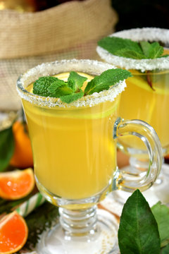 Yellow cocktail in Irish mugs decorated with sugar border and mint