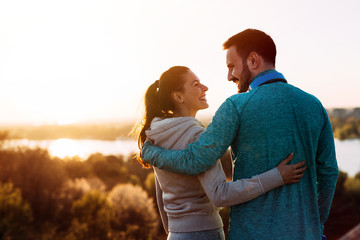 Happy young sporty couple sharing romantic moments