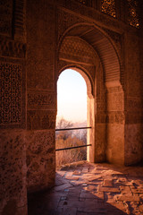 Arabian doors, with details on hand-carved walls and the sun entering through the door. Mosaic walls