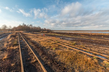 Landschaftsaufnahme eines Torfabbaugebietes mit Schienen einer Torfbahn