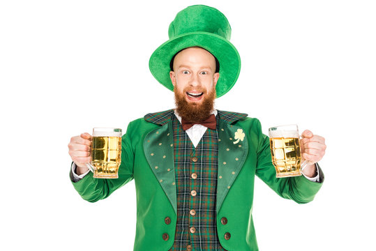 Smiling Leprechaun Celebrating St Patricks Day With Glasses Of Beer, Isolated On White